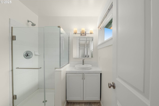 bathroom with a stall shower and vanity