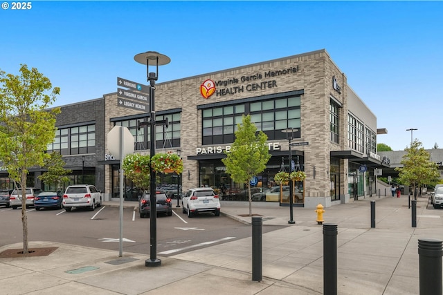view of commercial property with uncovered parking