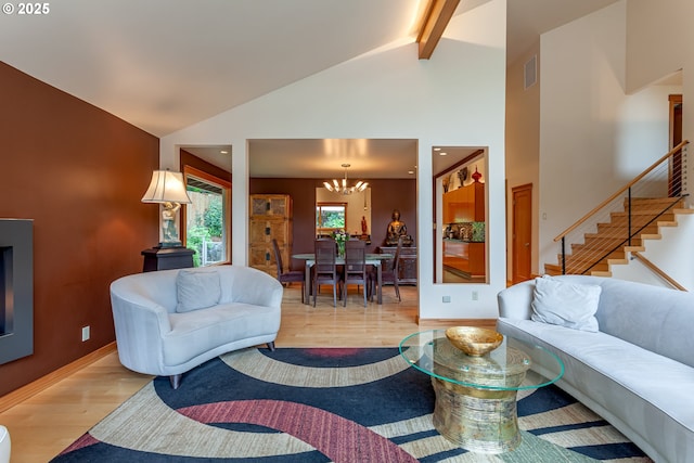 11 Da Vinci St, Lake Oswego, OR 97035 - living area featuring a chandelier, light wood-type flooring, beam ceiling, stairs, and high vaulted ceiling
