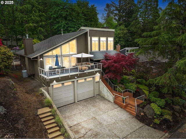 11 Da Vinci St, Lake Oswego, OR 97035 - view of front of home with driveway, an attached garage, a chimney, and stairway