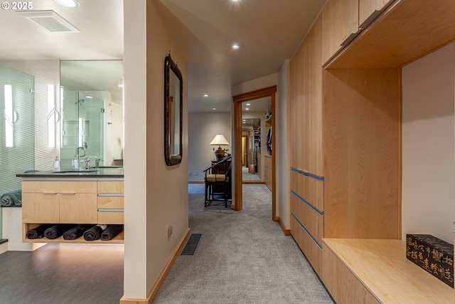 11 Da Vinci St, Lake Oswego, OR 97035 - hall with light colored carpet, recessed lighting, baseboards, and a sink