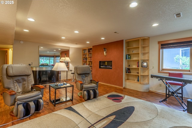 11 Da Vinci St, Lake Oswego, OR 97035 - living area featuring recessed lighting, wood finished floors, a textured ceiling, and baseboards