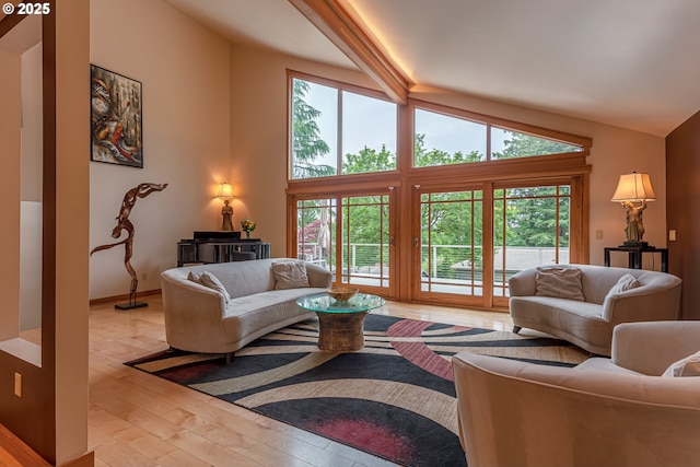 11 Da Vinci St, Lake Oswego, OR 97035 - living area featuring vaulted ceiling, light wood-style floors, healthy amount of natural light, and baseboards