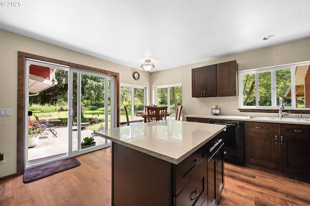 290 12th Ave, Hammond, OR 97121 - kitchen featuring black dishwasher, a kitchen island, a sink, dark brown cabinets, and light wood finished floors