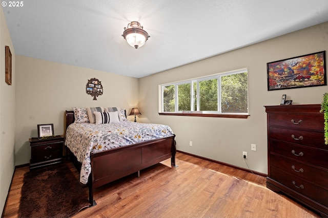 290 12th Ave, Hammond, OR 97121 - bedroom featuring light wood-style flooring and baseboards