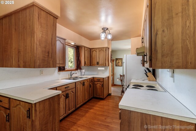 34546 Moore Rd, Scappoose, OR 97056 - kitchen featuring a sink, brown cabinets, wood finished floors, and light countertops