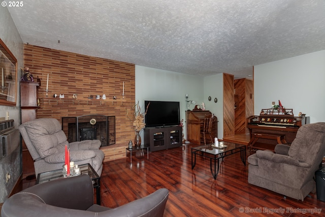 34546 Moore Rd, Scappoose, OR 97056 - living room featuring a textured ceiling, wood-type flooring, and a fireplace