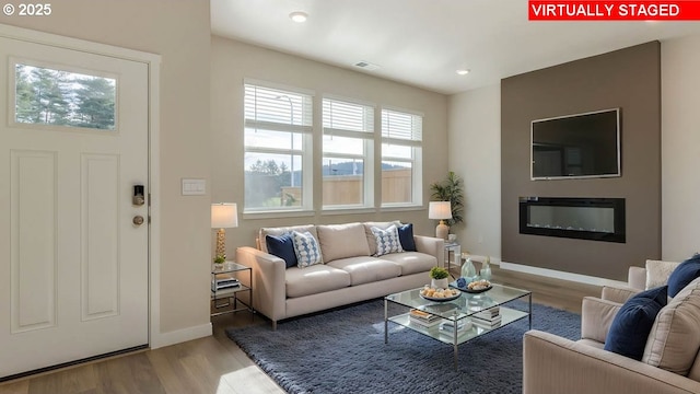 17197 SE Maple Hill Ln, Happy Valley, OR 97086 - living room with wood finished floors, a glass covered fireplace, and recessed lighting