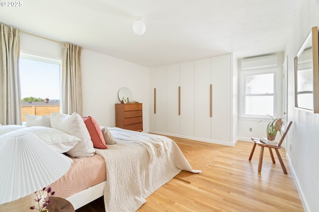 3511 NE Rosa Parks Way, Portland, OR 97211 - bedroom featuring light wood-type flooring, baseboards, and a wall mounted AC