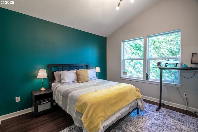 bedroom featuring vaulted ceiling, baseboards, and wood finished floors