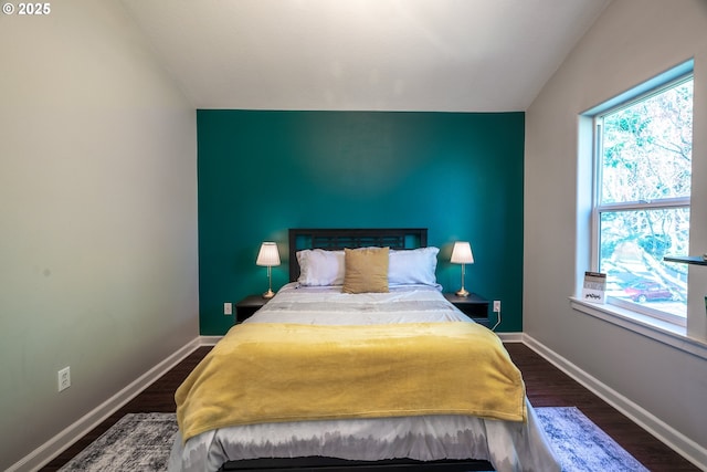 bedroom featuring dark wood finished floors and baseboards