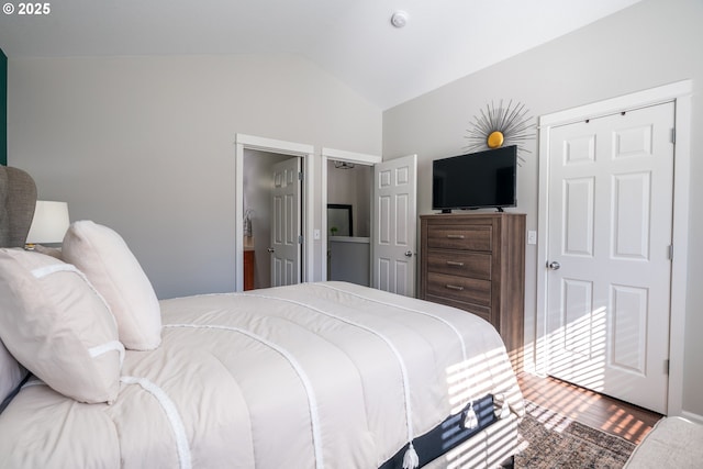 bedroom featuring vaulted ceiling and wood finished floors