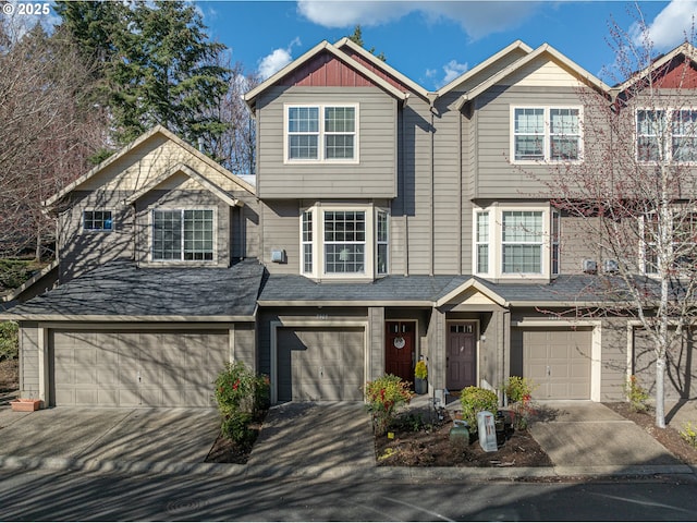 view of front facade featuring an attached garage, driveway, and board and batten siding