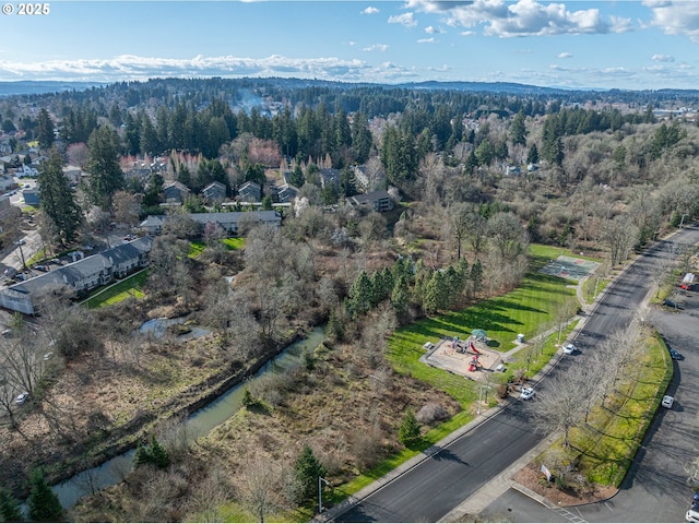 birds eye view of property featuring a wooded view