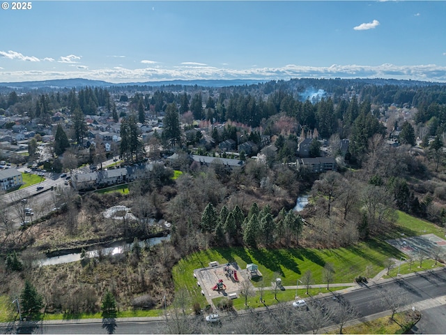 aerial view with a wooded view and a mountain view