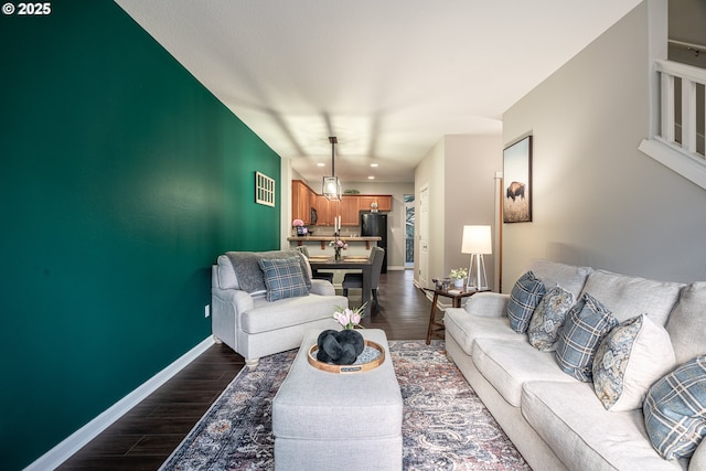 living area featuring visible vents, baseboards, and dark wood-type flooring