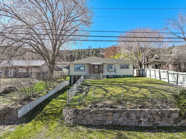 view of front facade with a front lawn and a fenced front yard