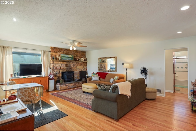 living area featuring a textured ceiling, recessed lighting, visible vents, a ceiling fan, and light wood finished floors