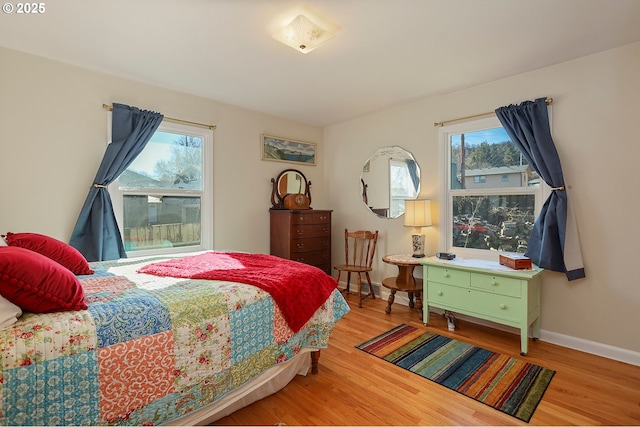 bedroom with baseboards and wood finished floors