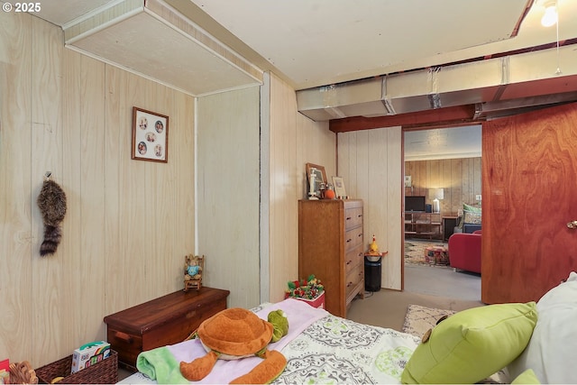 bedroom with wooden walls and concrete floors