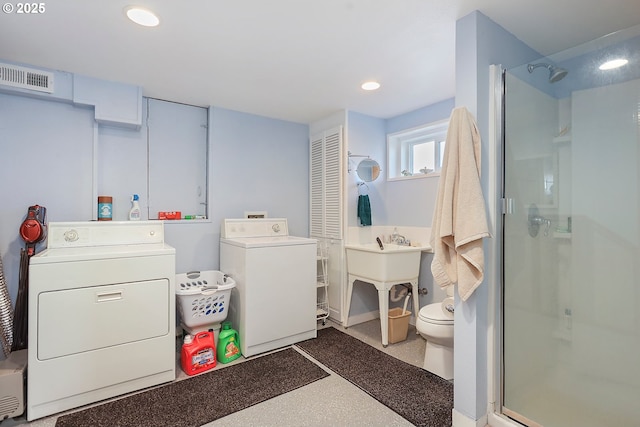 bathroom with recessed lighting, visible vents, toilet, a stall shower, and separate washer and dryer