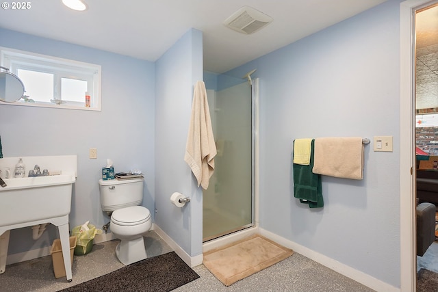 bathroom with visible vents, toilet, a stall shower, baseboards, and speckled floor