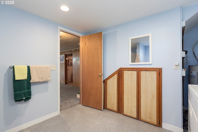 hallway with recessed lighting and baseboards