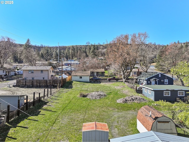 view of yard featuring fence and a residential view