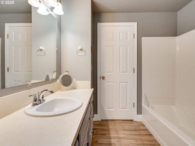 bathroom with wood finished floors and vanity