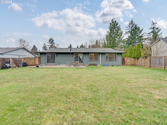 back of house with a lawn, a patio, and a fenced backyard