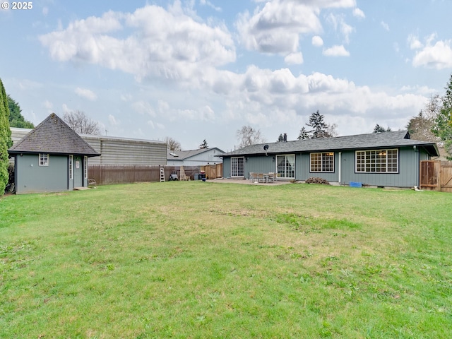 exterior space with a patio, an outdoor structure, and a fenced backyard