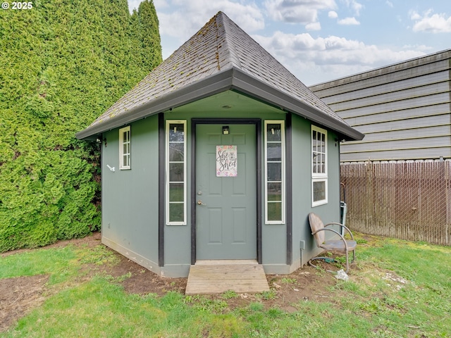 exterior space featuring an outbuilding and fence