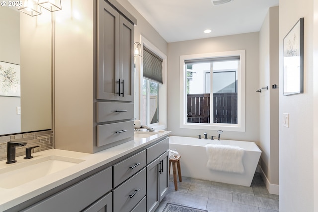 1718 SE 40th St, Brush Prairie, WA 98606 - full bathroom featuring double vanity, a freestanding bath, recessed lighting, and tasteful backsplash