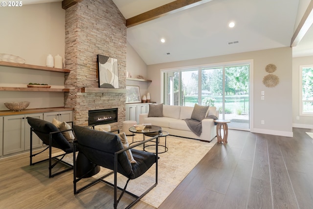 1718 SE 40th St, Brush Prairie, WA 98606 - living room with wood finished floors, beamed ceiling, a fireplace, and high vaulted ceiling
