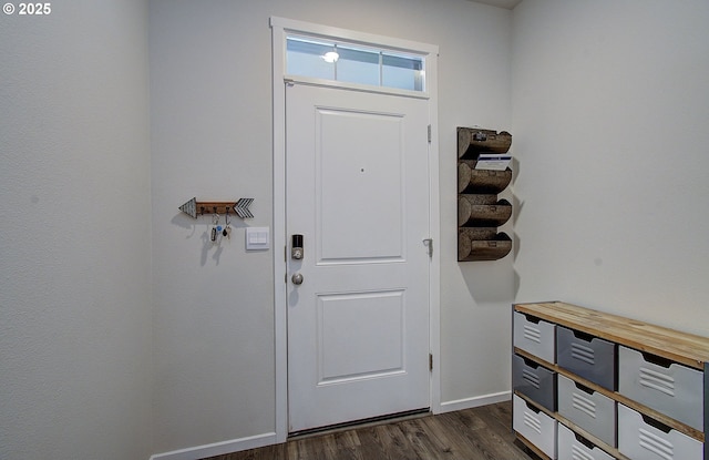 entryway with dark wood-type flooring and baseboards