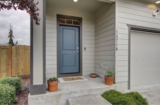 entrance to property with fence and a garage