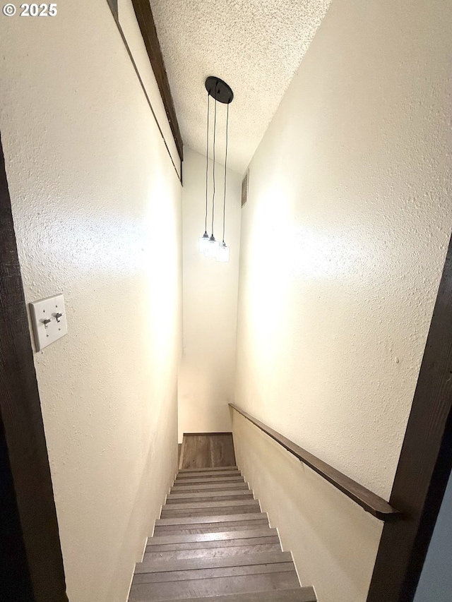 2011/2013 Ohio Ave, North Bend, OR 97459 - staircase featuring a textured ceiling, wood finished floors, and a textured wall