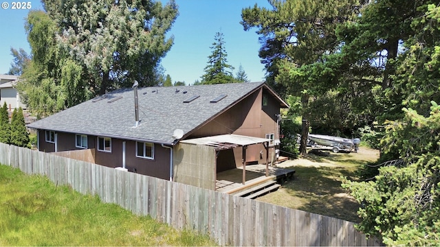 2011/2013 Ohio Ave, North Bend, OR 97459 - view of side of home featuring a shingled roof and a deck
