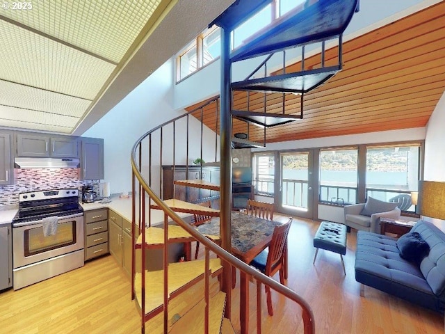 94304 Wedderburn Loop Unit 445, Gold Beach, OR 97444 - stairs featuring wood finished floors and high vaulted ceiling