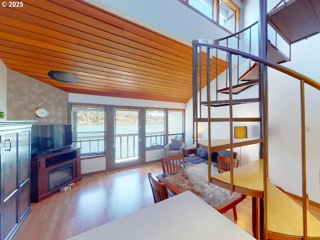 94304 Wedderburn Loop Unit 445, Gold Beach, OR 97444 - living room featuring healthy amount of natural light, wood finished floors, stairs, wooden ceiling, and a glass covered fireplace