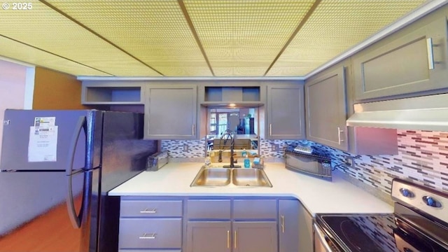 94304 Wedderburn Loop Unit 445, Gold Beach, OR 97444 - kitchen with freestanding refrigerator, stainless steel electric stove, a sink, open shelves, and decorative backsplash