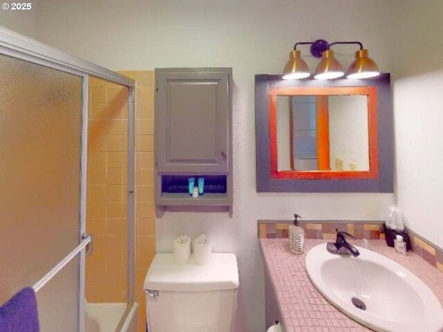 94304 Wedderburn Loop Unit 445, Gold Beach, OR 97444 - bathroom with toilet, shower / bath combination with glass door, and vanity