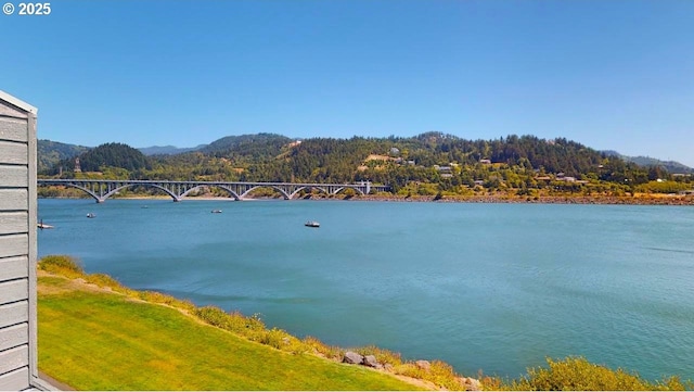 94304 Wedderburn Loop Unit 445, Gold Beach, OR 97444 - water view with a mountainous background and a notable bridge