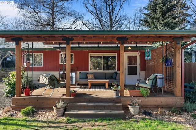 rear view of house with an outdoor living space and a wooden deck