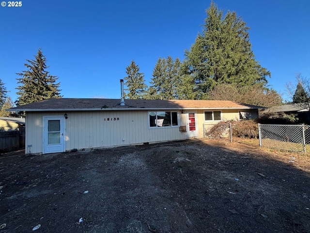 rear view of property with fence