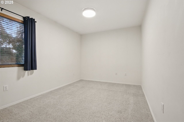 unfurnished room with baseboards and carpet