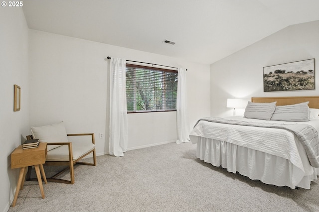 bedroom featuring visible vents, baseboards, lofted ceiling, and carpet floors