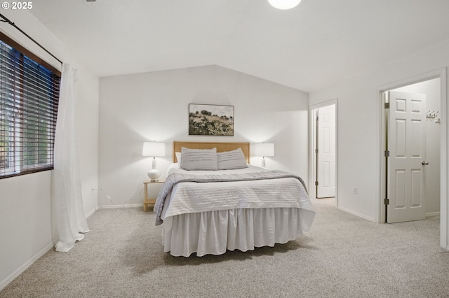 bedroom with lofted ceiling, baseboards, and carpet floors