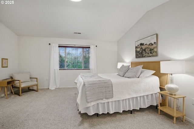 bedroom with visible vents, baseboards, vaulted ceiling, and carpet floors