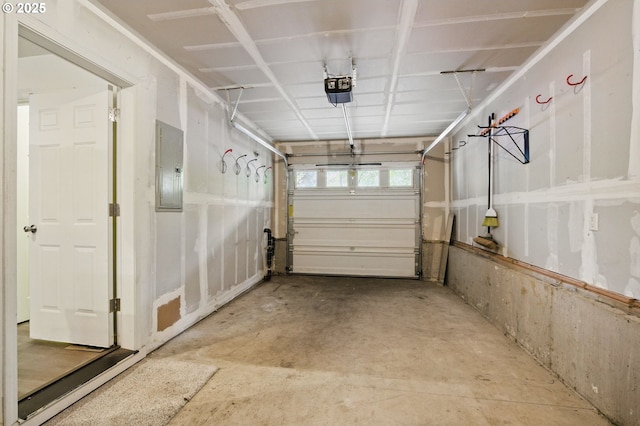 garage with a garage door opener and electric panel